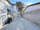 Property side yard featuring a concrete walkway, rock landscaping and partial view of the home's exterior at 2600 Congress Ave, Las Vegas, NV 89121