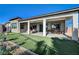 House backyard with covered patio and grassy area at 4829 E Beacon Ridge Dr, Pahrump, NV 89061