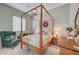 Spacious bedroom with a wooden canopy bed and a sitting area at 4829 E Beacon Ridge Dr, Pahrump, NV 89061
