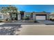 Modern two-toned house with attached garage and desert landscaping at 4829 E Beacon Ridge Dr, Pahrump, NV 89061