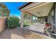 Covered patio with seating area and grassy backyard at 4829 E Beacon Ridge Dr, Pahrump, NV 89061