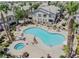Aerial view of community pool and spa with surrounding landscaping at 5710 E Tropicana Ave # 2017, Las Vegas, NV 89122
