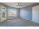 Spacious bedroom with large window, ceiling fan, and light grey walls at 5710 E Tropicana Ave # 2017, Las Vegas, NV 89122