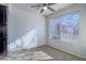 Bright bedroom with large window, ceiling fan, and carpet flooring at 5710 E Tropicana Ave # 2017, Las Vegas, NV 89122