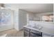 Simple kitchen with double sink, dark cabinets, and access to living area at 5710 E Tropicana Ave # 2017, Las Vegas, NV 89122