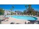 Inviting community pool with lounge chairs and patio tables at 5710 E Tropicana Ave # 2017, Las Vegas, NV 89122