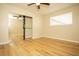 Bright bedroom with mirrored closet doors and ceiling fan at 749 Rossmore Dr, Las Vegas, NV 89110