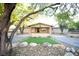 Ranch style home with landscaped yard, brick accents and large trees at 749 Rossmore Dr, Las Vegas, NV 89110