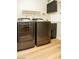 Laundry room with modern washer and dryer, and wood flooring at 749 Rossmore Dr, Las Vegas, NV 89110