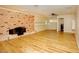 Living room with brick fireplace and light wood flooring at 749 Rossmore Dr, Las Vegas, NV 89110