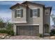 Two-story home with gray siding, brown garage door, and green shutters at 9132 Vesey Ave, Las Vegas, NV 89148