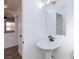 Clean bathroom with pedestal sink and mirror at 9369 Leaping Lilly Ave, Las Vegas, NV 89129