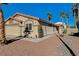 Spanish style home with a two-car garage and walkway at 1048 Sun Poppy Ave, Las Vegas, NV 89123