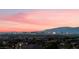 Expansive city view of the Las Vegas skyline at sunset, showing colorful lights and mountain backdrop at 1168 Spago Ln, Henderson, NV 89052