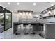 Well-lit kitchen featuring bar seating at an island, modern appliances and sliding door access to the backyard at 1168 Spago Ln, Henderson, NV 89052