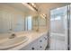 Clean bathroom with double sinks and a separate tub and shower at 1624 Ravanusa Dr, Henderson, NV 89052