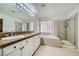Primary bathroom with granite double vanity, soaking tub and shower at 1624 Ravanusa Dr, Henderson, NV 89052