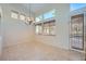 Bright dining area with high ceilings, chandelier, and large windows at 1624 Ravanusa Dr, Henderson, NV 89052