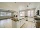 Kitchen features granite island, stainless steel appliances, and tiled floors at 1624 Ravanusa Dr, Henderson, NV 89052