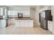 Bright kitchen with white cabinets, granite counters, and tile flooring at 1624 Ravanusa Dr, Henderson, NV 89052