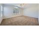 Main bedroom with ceiling fan, carpet, and large window at 1624 Ravanusa Dr, Henderson, NV 89052