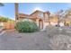 Tan two-story house with a well-maintained front yard and desert landscaping at 1717 Silver Point Ave, Las Vegas, NV 89123