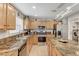 Modern kitchen with granite countertops and wood cabinets at 2121 Crestline Falls Pl, Las Vegas, NV 89134