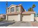 Beige two-story house with a three-car garage and mature palm trees at 3220 Cooper Creek Dr, Henderson, NV 89074