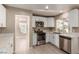 Modern kitchen featuring white cabinets, stainless steel appliances, and quartz countertops at 3220 Cooper Creek Dr, Henderson, NV 89074