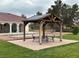 Outdoor patio with seating perfect for entertaining in a backyard with green grass at 390 China St, Pahrump, NV 89048