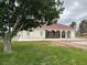 Stucco home featuring a large yard with mature trees and large pillars and a covered patio at 390 China St, Pahrump, NV 89048