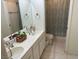 Bright bathroom featuring a double sink vanity and a shower-tub combination at 390 China St, Pahrump, NV 89048