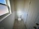 Small bathroom with white walls, tiled floor, and all the essential fixtures at 390 China St, Pahrump, NV 89048