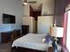 Bright bedroom with a ceiling fan, TV, dresser, and queen bed with white and blue accents at 390 China St, Pahrump, NV 89048