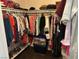 Walk-in closet with lots of hanging clothes, clothing storage, and shoes neatly organized in a bin at 390 China St, Pahrump, NV 89048