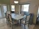 Bright dining room features a marble table set for six, complemented by natural light from large windows at 390 China St, Pahrump, NV 89048