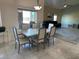 Bright dining room with a marble table set for six, and a clear view to the living room at 390 China St, Pahrump, NV 89048
