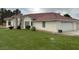 Charming home featuring a lush lawn, stucco exterior, a red tiled roof and an attached garage at 390 China St, Pahrump, NV 89048