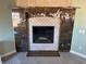Elegant fireplace with granite surround and hearth, creating a cozy focal point in the living space at 390 China St, Pahrump, NV 89048