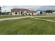 A spacious single-story home with stucco exterior, tile roof, and a large manicured lawn at 390 China St, Pahrump, NV 89048