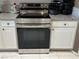 The kitchen has white cabinets, granite countertops, and stainless steel stove appliance at 390 China St, Pahrump, NV 89048