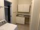 Laundry room featuring a laundry sink and some wall storage at 390 China St, Pahrump, NV 89048
