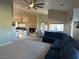 Spacious open-concept living room with modern sofa and seamless flow to dining and kitchen areas at 390 China St, Pahrump, NV 89048