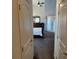 View into main bedroom with dresser, large bed, and outdoor access at 390 China St, Pahrump, NV 89048