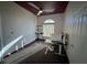 Home office featuring a ceiling fan, a desk with a monitor, and track lighting with a window at 390 China St, Pahrump, NV 89048