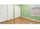 Bedroom with green walls and wood floors at 4020 Angel Face St, North Las Vegas, NV 89032