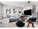 Modern living room showcasing a sectional sofa and large TV at 461 S Chesapeake Way, Henderson, NV 89015