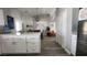 Modern kitchen with white cabinets and breakfast bar overlooking living room at 5271 Deanna St, Pahrump, NV 89048