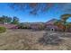 Spacious backyard with an open layout, surrounded by mature trees, shrubs, and a block wall at 5919 Pavilion Lakes Ave, Las Vegas, NV 89122