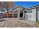 Backyard featuring a covered patio with neutral colored stone and some trees and shrubbery at 5919 Pavilion Lakes Ave, Las Vegas, NV 89122